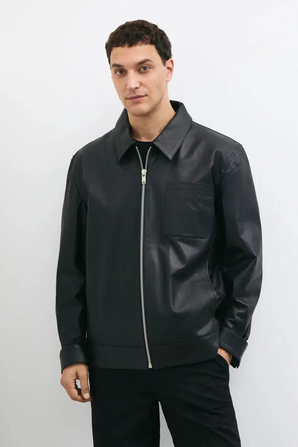 Men's black leather jacket made from premium full grain leather with front zipper closure, classic collar, and modern minimalist design by LEATHERTEXEU.