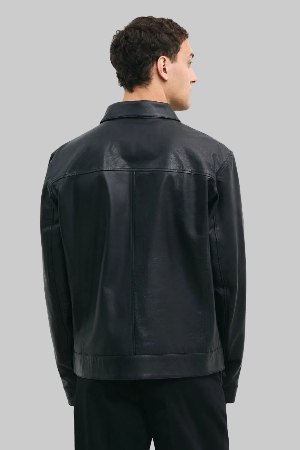 BACK POSE Men's black leather jacket made from premium full grain leather with front zipper closure, classic collar, and modern minimalist design by LEATHERTEXEU.