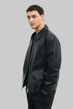 LEFT SIDE POSE Men's black leather jacket made from premium full grain leather with front zipper closure, classic collar, and modern minimalist design by LEATHERTEXEU.